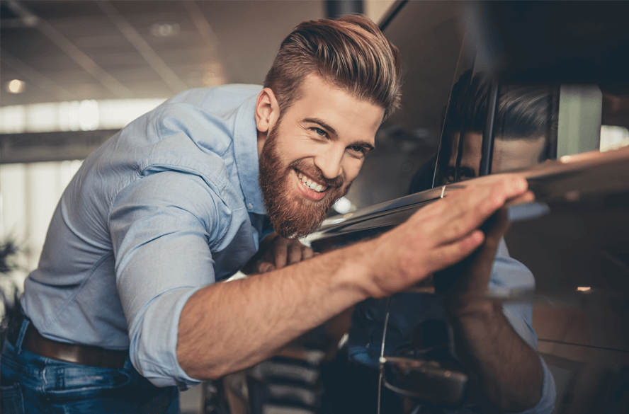 man looking at car