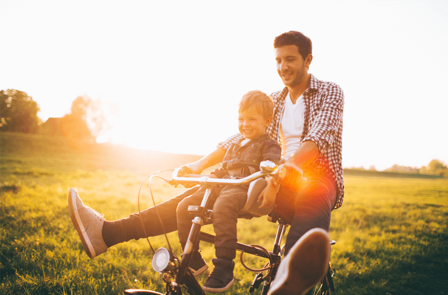 dad and son riding a bike