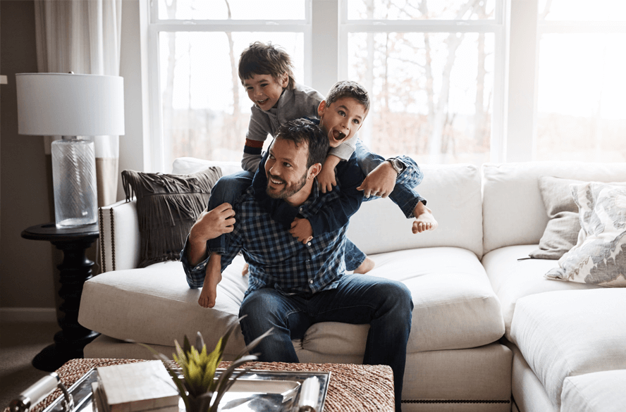 man with two sons on couch